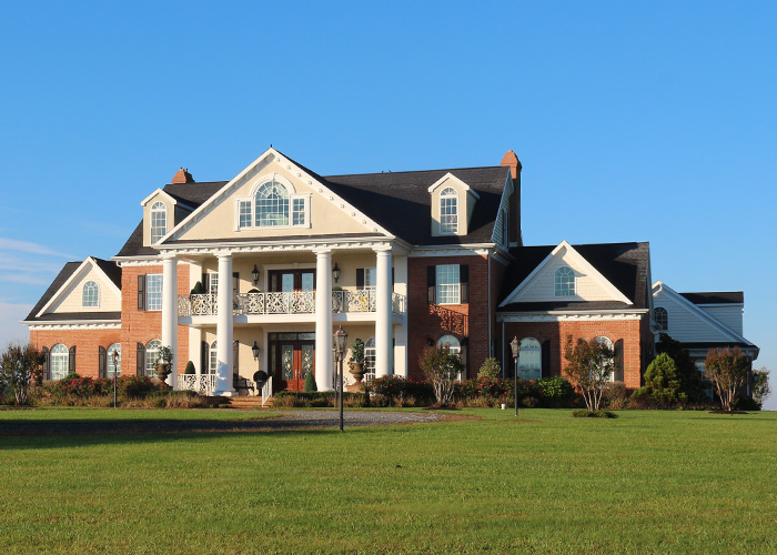 Exterior photo of a huge modular home mansion on land